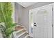 Bright entryway featuring a staircase, a side door, and a decorative plant at 716 Golfview St, Orlando, FL 32804