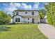 Charming two-story home with a landscaped lawn and a driveway leading to the front entrance at 716 Golfview St, Orlando, FL 32804