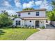 Charming two-story home with manicured lawn and driveway, and clearly visible address at 716 Golfview St, Orlando, FL 32804