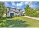 Charming two-story home with a landscaped lawn and a driveway leading to the front entrance at 716 Golfview St, Orlando, FL 32804