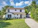 Charming two-story home with a well-maintained lawn and beautifully landscaped front yard at 716 Golfview St, Orlando, FL 32804