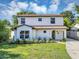Charming two-story home with a well-maintained lawn and beautifully landscaped front yard at 716 Golfview St, Orlando, FL 32804