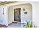 Inviting front porch featuring stylish tile flooring, a modern light fixture, and a mailbox at 716 Golfview St, Orlando, FL 32804