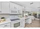 Open kitchen with white cabinets and quartz countertops, connecting to the living room at 716 Golfview St, Orlando, FL 32804