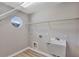 Functional laundry room with a utility sink, overhead shelving, and a unique window at 716 Golfview St, Orlando, FL 32804