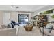 Open living room features stylish decor, light wood floors, comfortable seating, and a sliding glass door at 716 Golfview St, Orlando, FL 32804