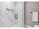 Luxurious shower with frameless glass door and marble tile at 716 Golfview St, Orlando, FL 32804