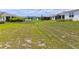 Large backyard with manicured lawn that offers ample space and leads towards neighboring houses at 8925 Sw 76Th St, Ocala, FL 34481