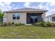 The backyard features a screened-in lanai and a lush, manicured lawn for relaxation and outdoor enjoyment at 8925 Sw 76Th St, Ocala, FL 34481