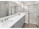 Bathroom featuring dual sinks, stone countertops, and a glass-enclosed shower for a luxurious feel at 8925 Sw 76Th St, Ocala, FL 34481