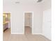 Bedroom with an ensuite bathroom and walk-in closet, featuring wood-look flooring and neutral wall paint at 8925 Sw 76Th St, Ocala, FL 34481