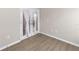 Versatile room with french doors with white curtains and wood-look flooring, perfect for a bedroom or office at 8925 Sw 76Th St, Ocala, FL 34481