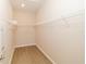 Spacious walk-in closet with built-in shelving and wood-look flooring, ready for storage and organization at 8925 Sw 76Th St, Ocala, FL 34481