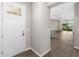 Welcoming entryway featuring a white door with glass and views of the open floor plan and outdoor patio at 8925 Sw 76Th St, Ocala, FL 34481