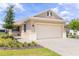Charming single-story home with a neutral color scheme, well-manicured landscaping, and an attached two-car garage at 8925 Sw 76Th St, Ocala, FL 34481