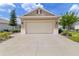 Two car garage shows a well maintained driveway and manicured lawn at 8925 Sw 76Th St, Ocala, FL 34481
