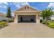 Two car garage shows a well maintained driveway and manicured lawn at 8925 Sw 76Th St, Ocala, FL 34481