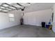Clean garage interior with water heater, door to the house and an automatic garage door opener at 8925 Sw 76Th St, Ocala, FL 34481