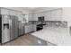 Modern kitchen with stainless steel appliances, granite countertops, gray cabinets, and mosaic tile backsplash at 8925 Sw 76Th St, Ocala, FL 34481