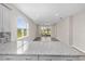 Open floor plan of the living area and kitchen with granite countertops and stainless steel appliances at 8925 Sw 76Th St, Ocala, FL 34481