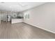 Bright and airy living space with hardwood floors, light gray paint, an adjacent kitchen, and lots of natural light at 8925 Sw 76Th St, Ocala, FL 34481