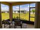 Relaxing screened-in lanai with comfortable chairs and view of the backyard and neighboring houses at 8925 Sw 76Th St, Ocala, FL 34481