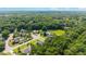 An aerial view of houses in a wooded suburban community with lush green surroundings and blue skies at 5005 Se 47Th Terrace Rd, Ocala, FL 34480