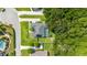A home with a private pool, lush green lawn, and a solar panel roof nestled amongst mature trees at 5005 Se 47Th Terrace Rd, Ocala, FL 34480