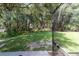 Large grassy backyard featuring mature trees and a charming fire pit seating area at 5005 Se 47Th Terrace Rd, Ocala, FL 34480