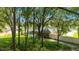 A backyard of a home with a screened-in pool surrounded by lush greenery and trees at 5005 Se 47Th Terrace Rd, Ocala, FL 34480