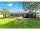 Expansive backyard with screened-in pool, palm tree, and well-maintained lawn at 5005 Se 47Th Terrace Rd, Ocala, FL 34480