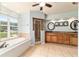 Bright bathroom featuring a soaking tub, shower, double vanity, and tile flooring at 5005 Se 47Th Terrace Rd, Ocala, FL 34480