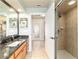 Bathroom showcasing a granite vanity with walk-in shower and natural light at 5005 Se 47Th Terrace Rd, Ocala, FL 34480