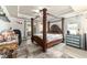 Spacious primary bedroom with decorative four poster bed, natural lighting at 5005 Se 47Th Terrace Rd, Ocala, FL 34480