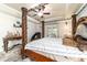 This primary bedroom boasts a four poster bed, trey ceilings, and great natural light at 5005 Se 47Th Terrace Rd, Ocala, FL 34480
