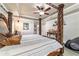 Spacious primary bedroom with decorative four poster bed and neutral color palette at 5005 Se 47Th Terrace Rd, Ocala, FL 34480