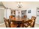 Dining room featuring a rustic table with six chairs and sliding barn doors with kitchen view at 5005 Se 47Th Terrace Rd, Ocala, FL 34480