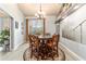 Cozy dining room featuring a chandelier, a round table, and bright, natural lighting at 5005 Se 47Th Terrace Rd, Ocala, FL 34480