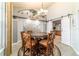 Cozy dining room with rustic wood table, decorative chandelier, and sliding barn doors to the kitchen at 5005 Se 47Th Terrace Rd, Ocala, FL 34480