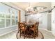 Inviting dining area featuring a large window, stylish chandelier, and seating for six at 5005 Se 47Th Terrace Rd, Ocala, FL 34480