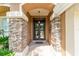 Welcoming entrance with stone pillar accents, stylish lighting, and a clear view of the front door at 5005 Se 47Th Terrace Rd, Ocala, FL 34480