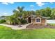 Charming home featuring a well-maintained lawn, decorative fountain, and lush landscaping at 5005 Se 47Th Terrace Rd, Ocala, FL 34480