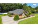 Well-maintained home with a long driveway and mature landscaping at 5005 Se 47Th Terrace Rd, Ocala, FL 34480