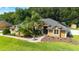 Inviting single-story home with a lush front lawn and stone accents at 5005 Se 47Th Terrace Rd, Ocala, FL 34480