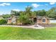 Beautiful single-story home with a well-manicured lawn and a lovely fountain in the front yard at 5005 Se 47Th Terrace Rd, Ocala, FL 34480