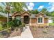 Charming exterior view with stone accents, featuring lush landscaping and a welcoming entrance walkway at 5005 Se 47Th Terrace Rd, Ocala, FL 34480