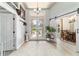 Spacious foyer with neutral tile flooring and views into the dining room and front entryway at 5005 Se 47Th Terrace Rd, Ocala, FL 34480