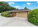 Spacious two-car garage with a concrete driveway and well-maintained surrounding landscape at 5005 Se 47Th Terrace Rd, Ocala, FL 34480
