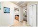 Hallway featuring a bathroom with wood cabinets and a bedroom with a fan and natural light at 5005 Se 47Th Terrace Rd, Ocala, FL 34480