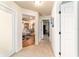 Hallway view showcasing open floorplan, light-colored walls, and neutral tile flooring at 5005 Se 47Th Terrace Rd, Ocala, FL 34480